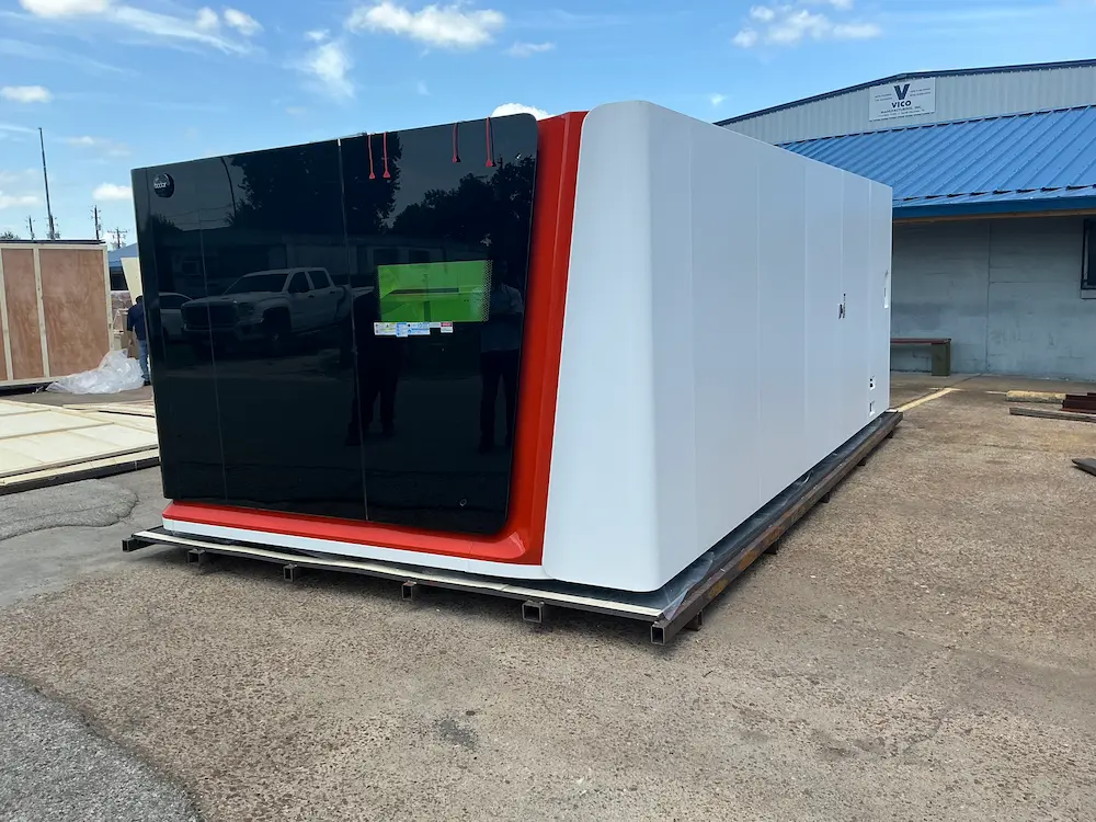Side-angle view of a large red and white Bodor laser cutter protective enclosure.